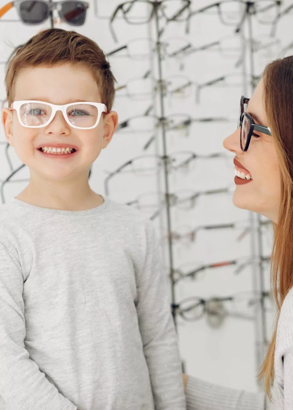 Mother with little son in the glasses store Mother with cute son. Family buy glasses